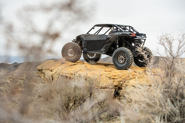 Black UTV side by side on cliff looking out into the valley below - mobile optimized